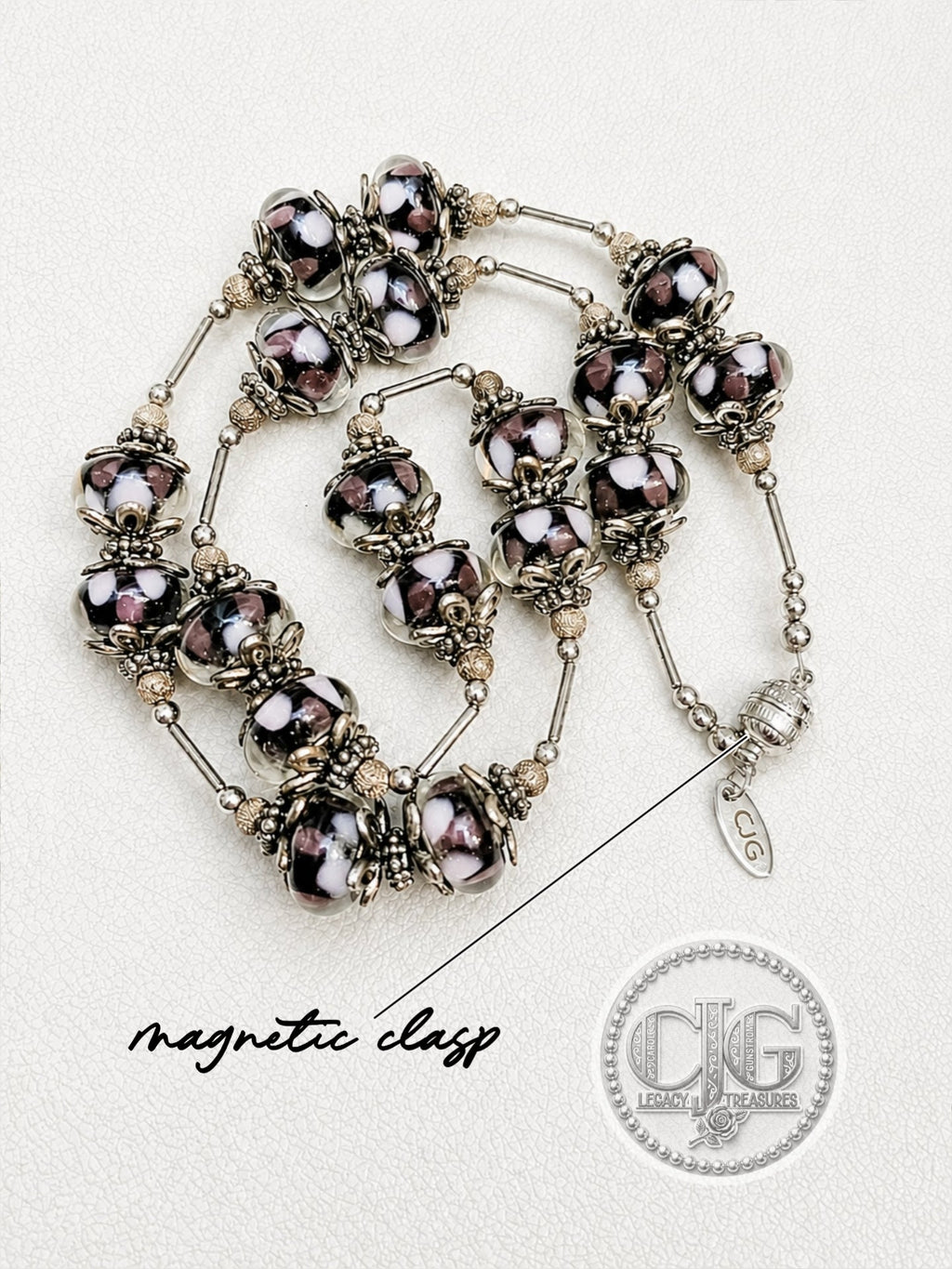 Full necklace coiled on white surface showing complete design