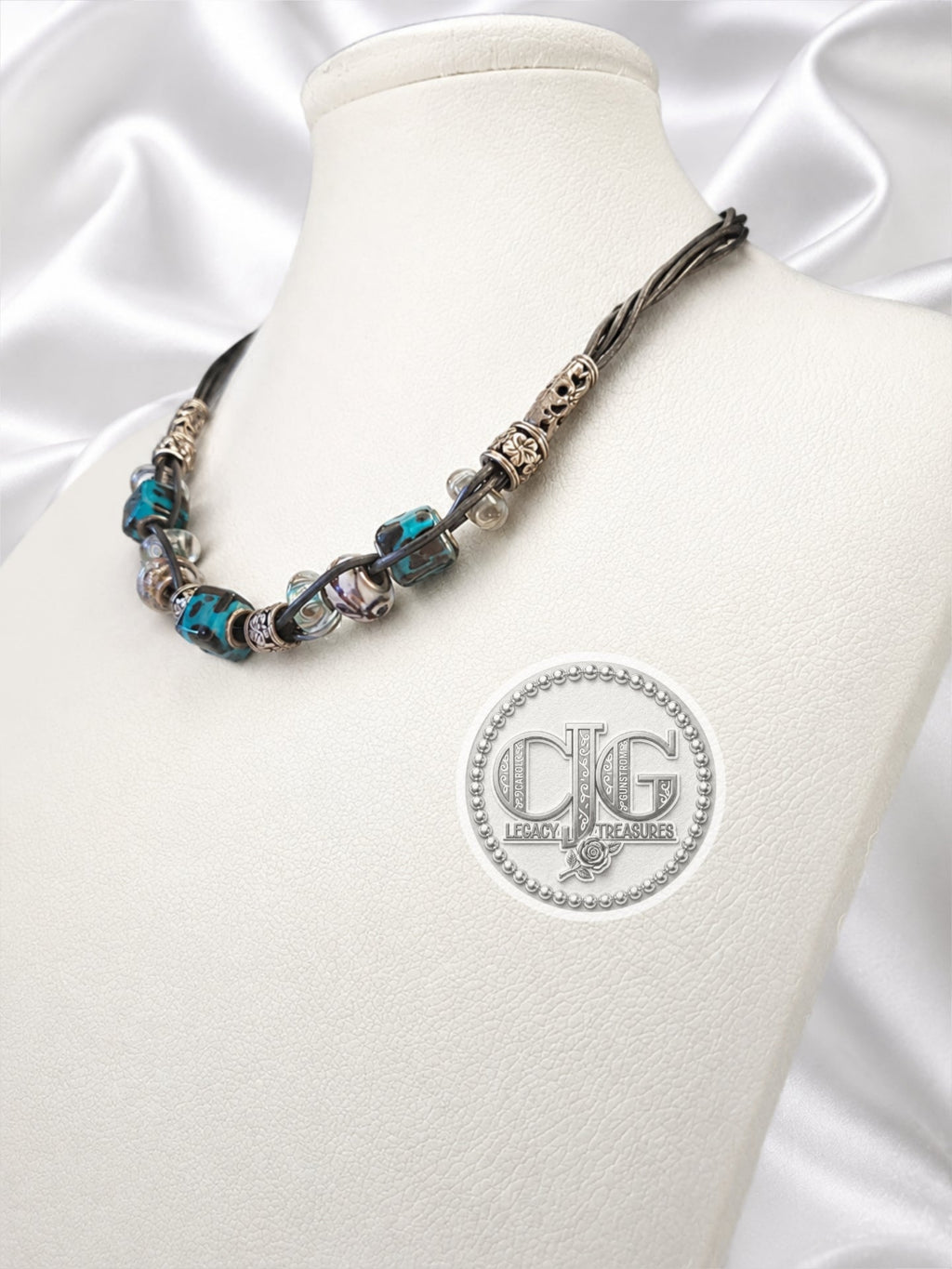 Teal leopard lampwork necklace and bracelet set flat lay on white background