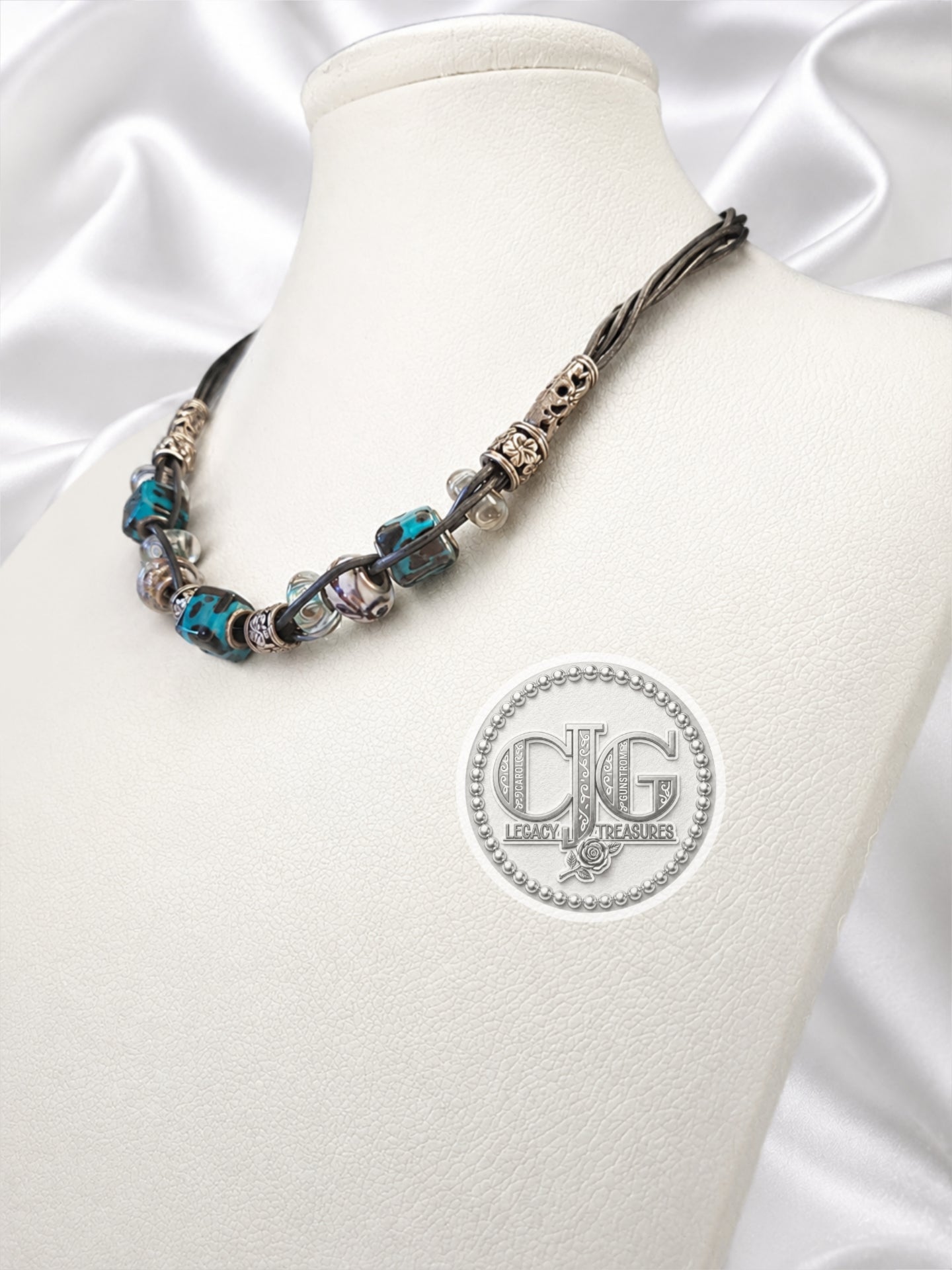Teal leopard lampwork necklace and bracelet set flat lay on white background