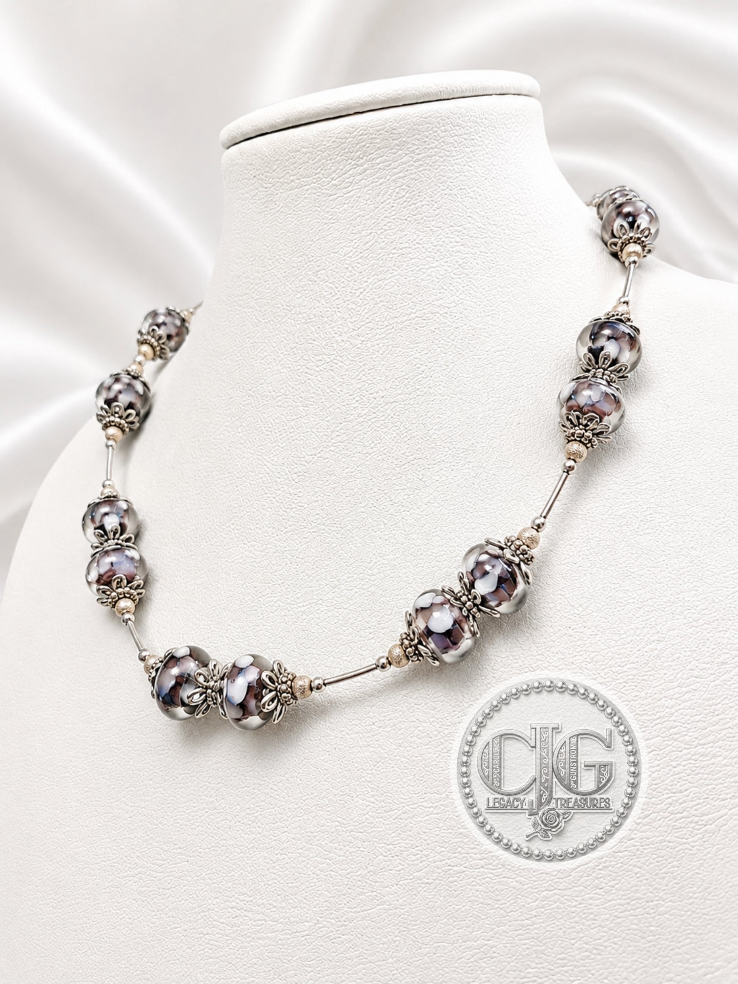 Midnight Bloom necklace draped on white jewelry bust, front view