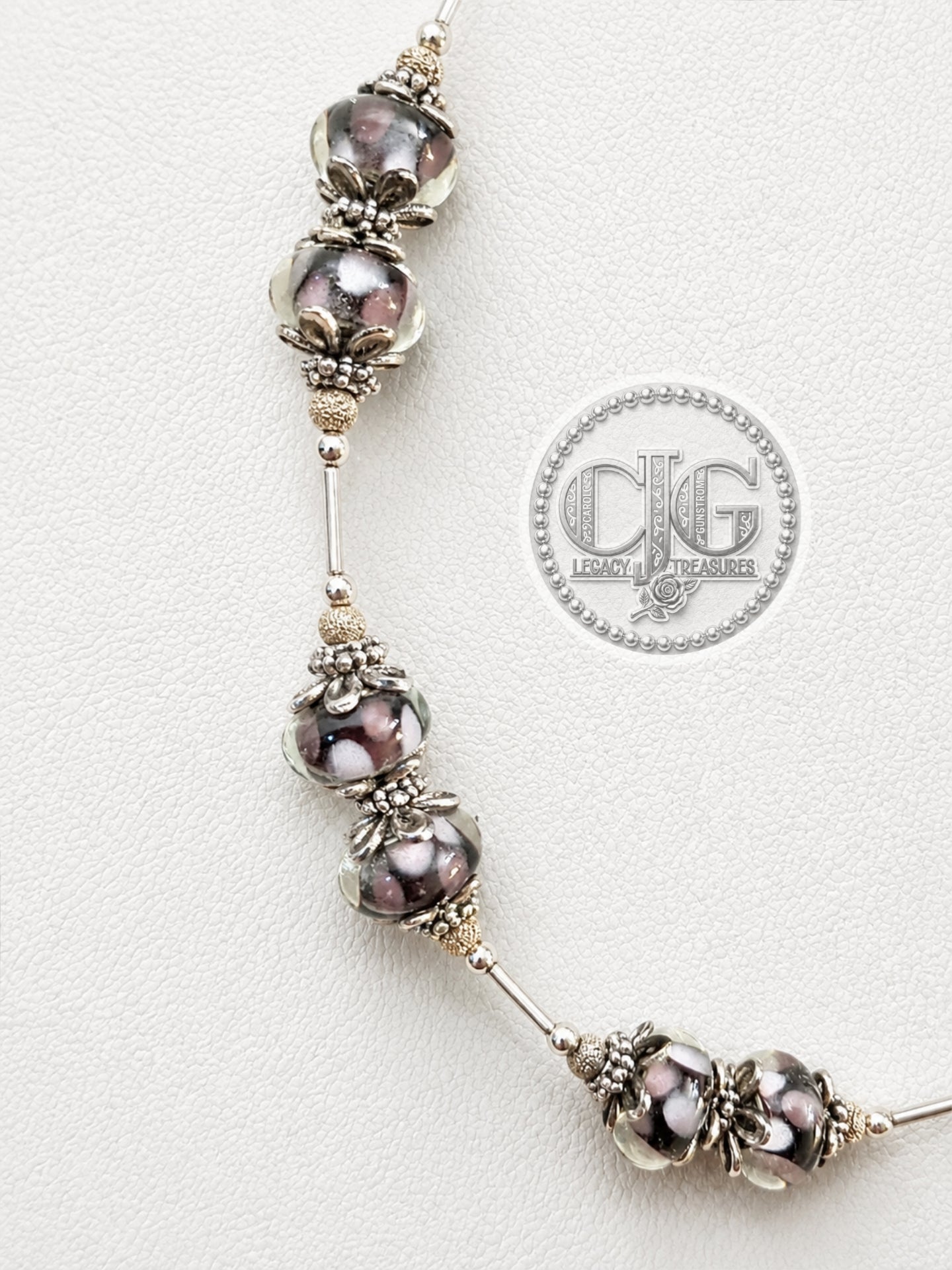 Midnight Bloom necklace on white jewelry bust, angled view showing full drape