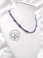 Close-up of graduated baroque pearl design in deep violet