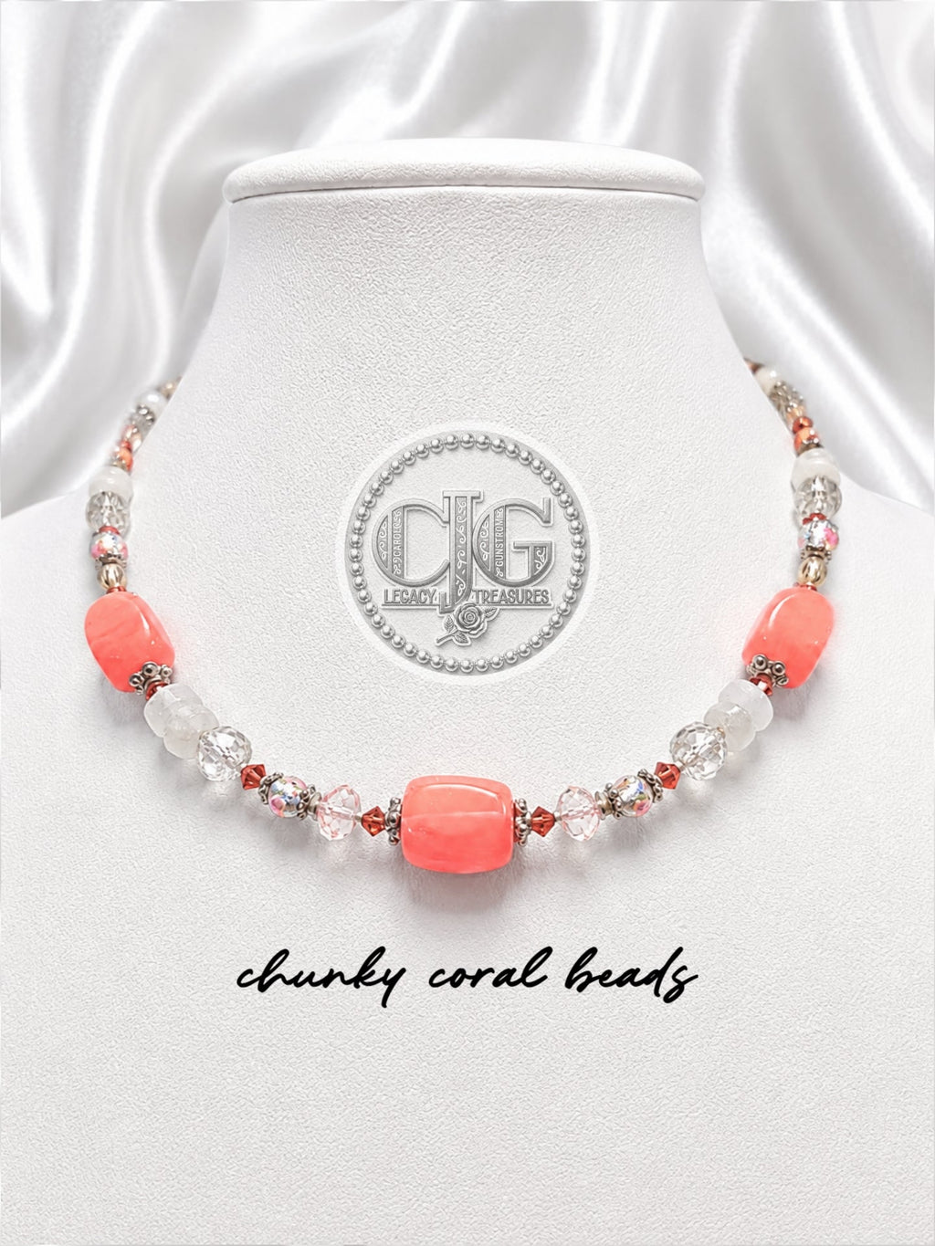 Full necklace laid flat showing coral, moonstone, crystal, and lampwork bead arrangement