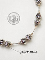 Flat lay close-up of full necklace showing bead pattern and silver spacers