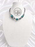Close-up of woven braid technique on teal leopard lampwork necklace