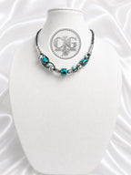 Close-up of woven braid technique on teal leopard lampwork necklace
