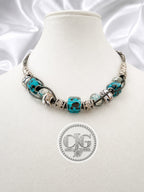 Teal leopard lampwork necklace displayed on CJG branded black card with lobster claw clasp detail